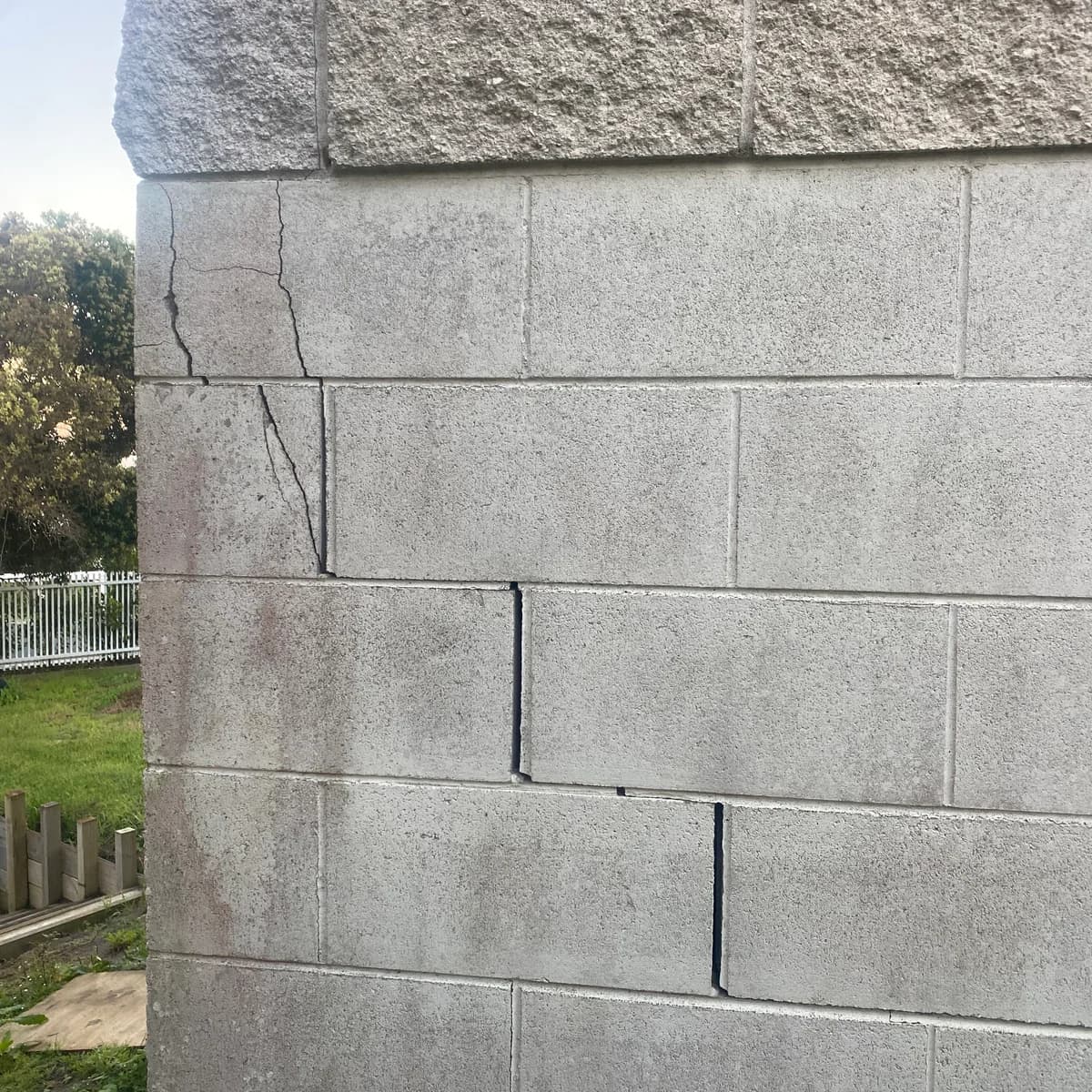 A clear stepped crack in a concrete block