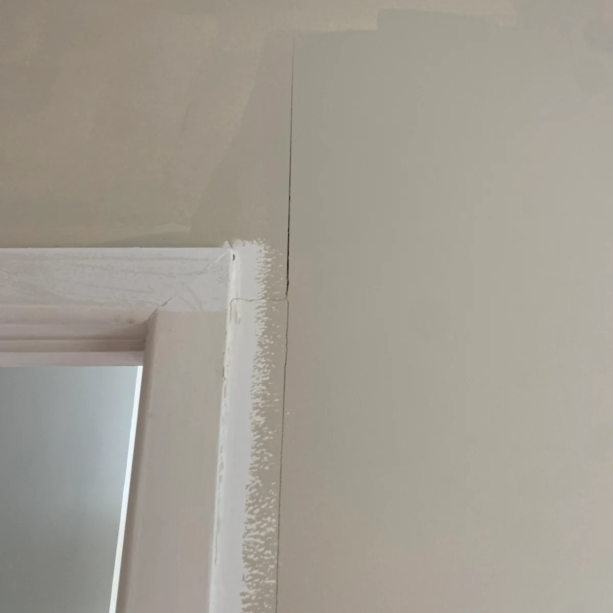 A visible crack in an interior plasterboard wall